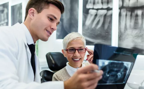 Dentist reviewing chart with patient.